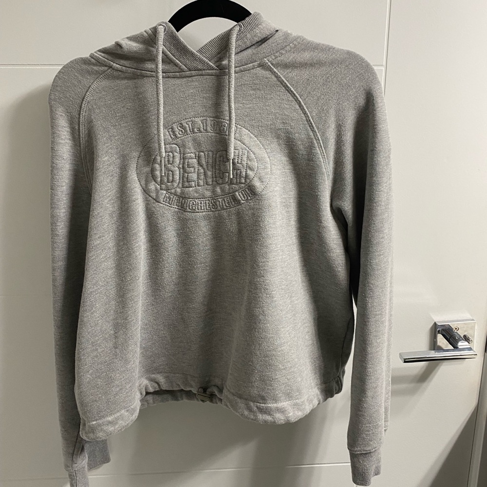 bench slightly cropped gray sweater